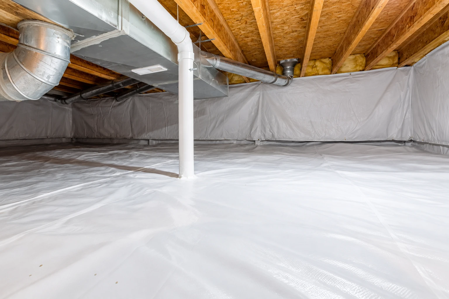 Crawl space lined with white vapor barrier plastic across the floor and lower walls beneath exposed joists and ductwork.